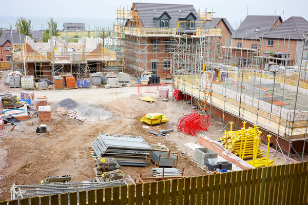 Llandudno, North Wales, UK, 09-08-2024. Residential construction site with scaffolding and building materials in an urban area.