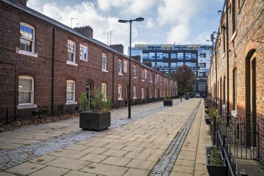 Charming street with brick built terraced houses in Manchester city center. clipart