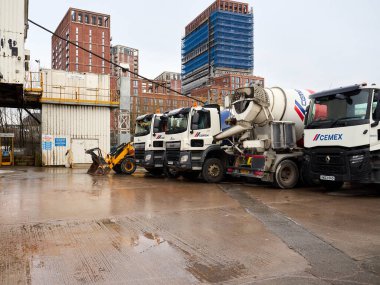 Salford, Manchester, İngiltere. 4 Ocak 2025: CEMEX çimento kamyonları geliştirme aşamasındaki bir kentsel alanda inşaat alanında.