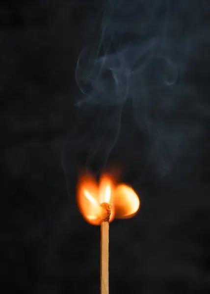 burning candle with smoke isolated on black background.