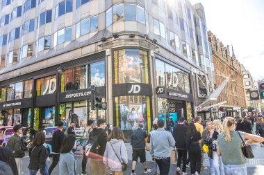 London, UK- August 6, 2023: JD Sports fashion brand store on Oxford Street, landmark retail destination. clipart