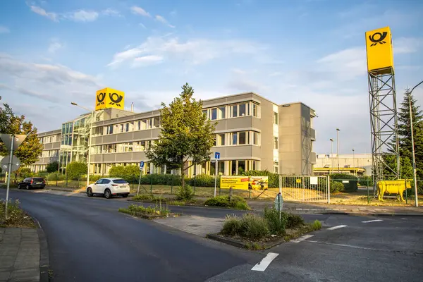 stock image Cologne, Germany- July 21, 2023: Deutsche post office aktie gelb bull in front.