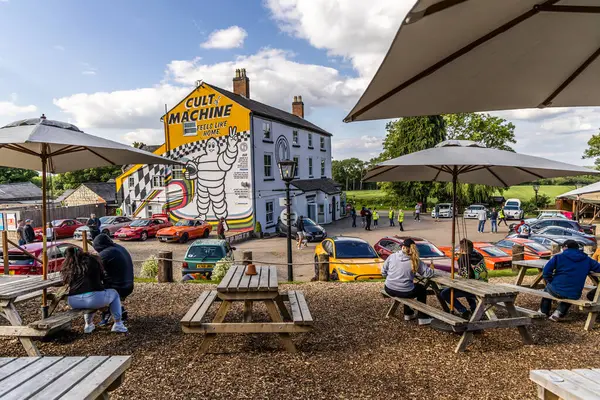 stock image Ettington , UK - June 5, 2024: Popular Caffeine and Machine The Hill Car Enthusiast meeting place. A Vies from outside eating area.