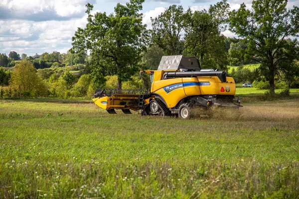 stock image Aluksne, Latvia - November 25, 2023: New Holland combine harvester in operation harvesting.