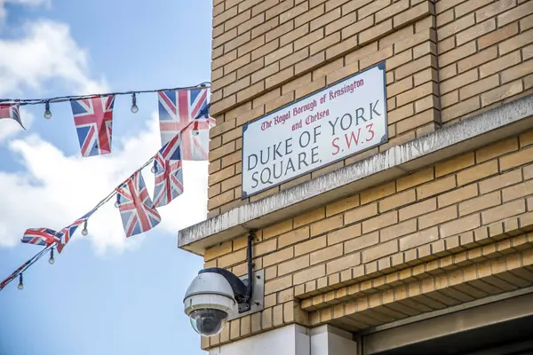 stock image London, UK- August 19, 2023: Duke of York Square sign and British Union Jack flags.
