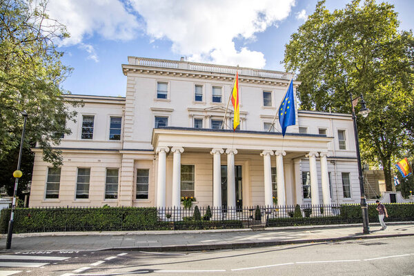 London, UK- August 19, 2023: The Spanish and EU flags flying over the entrance and facade to the Embassy of Spain in London's Belgravia district