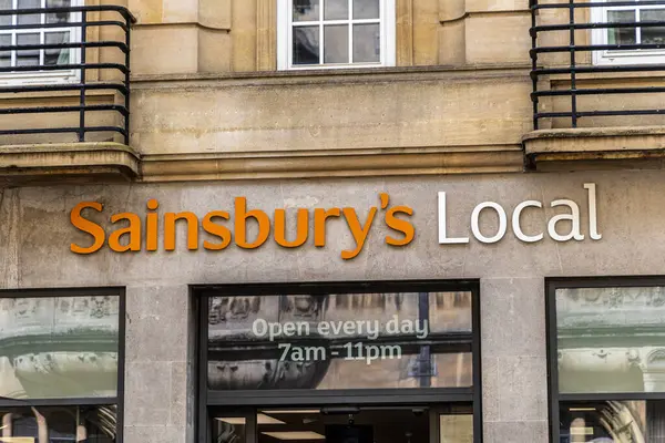 Stock image Oxford , UK - June 5, 2024: The large orange Sainsbury's Local supermarket logo sign above the main entrance.