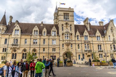 Oxford , UK - June 5, 2024: The view of the Main entrance of Balliol College Porters' Lodge from the Broad Street with the many bicycles parked in front of the building. clipart