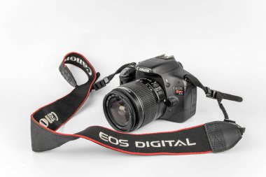 Bristol, UK- August 31, 2023: Canon EOS 550d Rebel T2i DSLR Camera body with stock kit lens 18-55mm. clipart