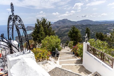 Holy Monastery of the Virgin Mary Tsambika Kyra Psili 300 white steps to reach it. clipart