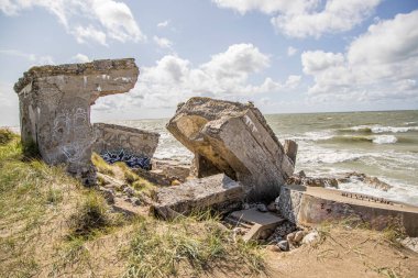 Ruins of bunkers on the beach of the Baltic sea, part of an old fort in the former Soviet base Karosta in Liepaja, Latvia. clipart