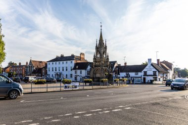 Stratford-upon-Avon, UK - June 5, 2024: City center around The Shakespeare Memorial Fountain and Street and Tudor houses. clipart