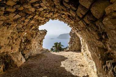 Castle of Monolithos. Ruins of a 15th century castle built on a cliff with picturesque views of the sea. clipart