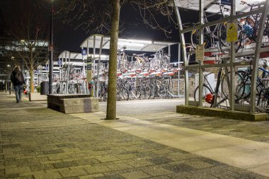 Bristol, England UK - February 12 2023: Bicycle, Bike storage facilities at Temple Meads train station at night. clipart