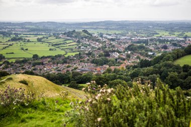 Glastonbury, UK- August 4, 2023: A view from Glastonbury Tor St Michaels hill to Glastonbury town village. clipart