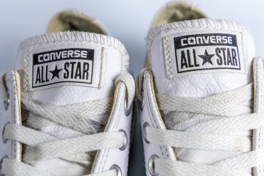Bristol, UK- 30 Aralık 2024: Lastik tabanda kırmızı ve mavi çizgili çift beyaz Converse All Star spor ayakkabısı.