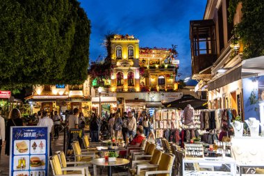 Rodos, Yunanistan - 9 Mayıs 2024: Alışveriş merkezinden geçen turistler. Rodos 'un Rodos şehrindeki Evreon Martiron Caddesi' nde..