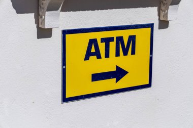 Beyaz Duvardaki Parlak Sarı ATM Yönetmeni: Santorini 'de Kullanışlı Para Erişimi.