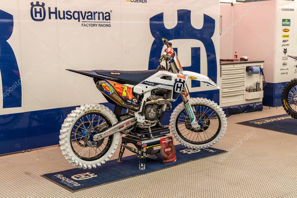 Winchester, UK- October 5, 2024: Husqvarna Factory Racing setup with white dirt bike on stand ready for competition.