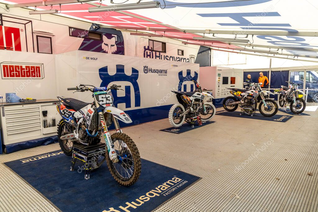 Winchester, UK- October 5, 2024: Pro motocross machine in Husqvarna pit area featuring custom decals and sponsor oil.