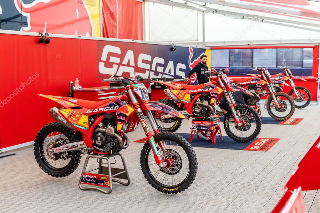 Winchester, UK- October 5, 2024: Bright red GasGas motocross bikes displayed in a racing garage.