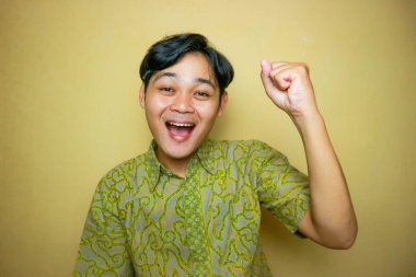 Ulusal Batik Günü 'nde Batik kıyafetler giyen Asyalı Endonezyalı bir adam.