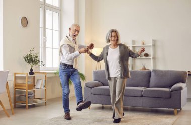 Kıdemli çift dansı, havalı mutlu dans, aktif yaşlı yetişkinler keyif gösteriyor, iyi yaşlı insanlar, evde birlikte yaşayan yaşlı çift aile, pozitiflik, memnuniyet ya da keyif hissi.