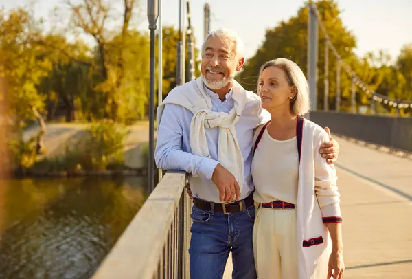 Senior couple during leisurely stroll in a charming city park. This portrait conveying the happiness of vacation and holiday, as the couple shares smiles while immersed in the beauty of nature.