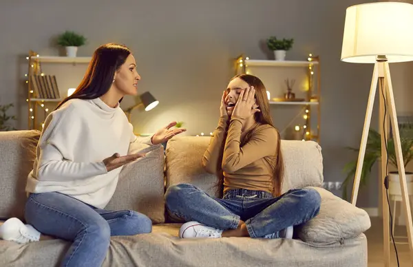 stock image Mother calms down upset, distraught, desperate, crying ADHD child daughter, reasoning that difficult relationship with friends, school quarrel, bad behavior and mistake in hard test are not disaster