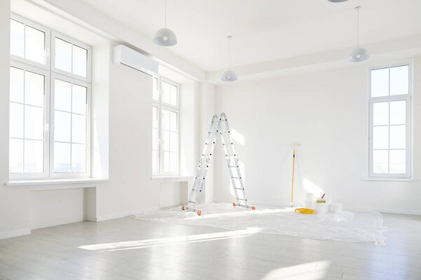 Interior of an empty house or office undergoing renovation or construction. The home room is in the repair stage, with a focus on improvement and creating a new, refreshed apartment space.