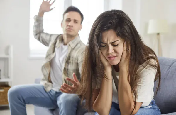 Stock image Physical abuse, frightened scared young defenseless woman victim hiding from aggressive man attack, abusive husband threaten to beat upset crying wife with hand, fear of domestic violence at home