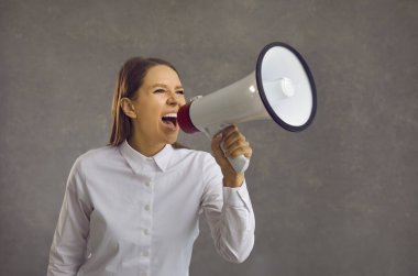 Woman in a white blouse was shouting loudly into a megaphone. An agitated salesperson, office worker, or corporate manager yells into a loudspeaker like crazy when announcing a sale. clipart