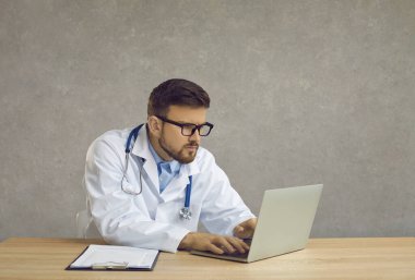 Doktor hasta kişiyi okuyor. Hastanenin bilgisayarındaki veri tabanını inceliyorum. Tedaviyi düzgün tutmak için. Modern tedavi internet üzerinden tavsiyelerde bulunabilir. Konsept Tıp Hastanesi