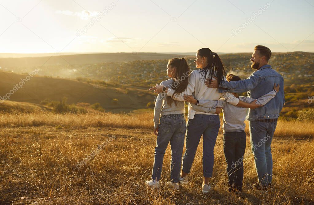 Happy family together enjoy nature rear view portrait. Parents and kids standing close, show affection, feelings, love, caring for each other, admiring sun, spending weekend, adventure holiday trip