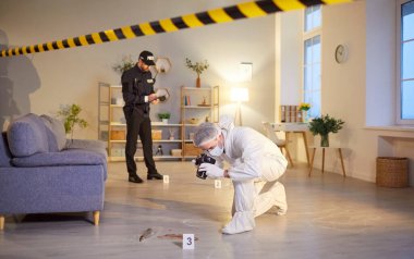 Photographing evidence, crime scene photography, investigator, policeman and professional criminological expert white coverall inspecting, examining behind barricade tape, yellow police line, safety clipart