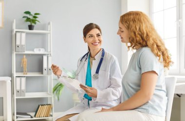 Mutlu kadın terapist, profesyonel danışman kadın müvekkil, ciddi genç doktor paylaşılan hasta tedavileri, hastalıkları önleme veya iyileştirme tavsiyeleri, kadın sağlığı