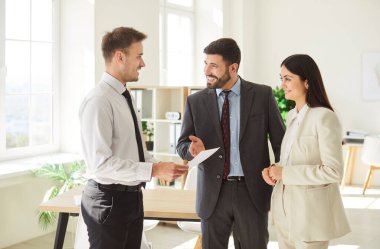 İşyerindeki üç iş adamının portresi başarılı bir anlaşmayı tartışıyor ya da sözleşme imzalıyor. İş arkadaşları, yeni projeleri değerlendirmek için iş arkadaşlarıyla görüşüyorlar..