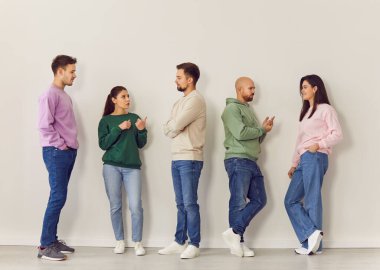 Bir grup profesyonel, meslektaş, personel ya da öğrenci, ofis toplantısı sırasında konuşma ve iletişim. Ortak atmosfer, etkin takım çalışması ve iş yerinde profesyonel etkileşimler.