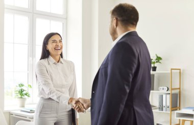Mutlu ofis, başarılı bir şekilde gülümseyen iş adamı adayının elini sıkmak. Yeni iş müdürünün müşteri ile harika bir anlaşma yapması, farklı ortaklarla selamlaşması, profesyonel iş arkadaşı...