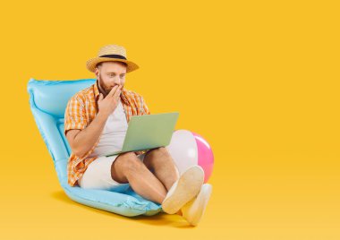 Adam yaz tatilinin tadını çıkarırken dizüstü bilgisayarında gördüğü sevinçli beklenmedik haberle şok oldu. Adam şişme sandalyeye oturur ve elini ağzını şaşkınlıkla kapatarak dizüstü bilgisayara bakar. Pankart