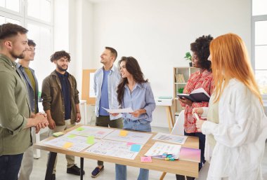 İş arkadaşları ofiste bir toplantı veya konferans sırasında evrak işleri ve bir iş planı oluşturma konusunda işbirliği yaparlar. Ekip muhasebe ve iş planlamasına odaklanıyor, profesyonel olarak birlikte çalışıyorlar..