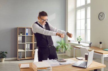 İş yerinin yanındaki masada duran heyecanlı genç muhasebecinin portresi başarılı bir işten zevk alıyor. Mutlu erkek kişi mali belgelerle çalışmada başarılı oluyor