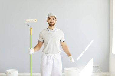 Profesyonel mutlu erkek servisi, başarılı ressam, boya fırçalı inşaat işçisi, ticari dekorasyon için kova aleti, pürüzsüz, profesyonel duvar kapağı.