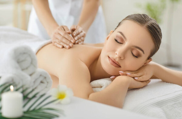 Back massage and aromatherapy, therapist hands massaging female body for relaxation, calm, therapeutic well-being, soothing treatment in modern beauty clinic, feeling of comfort, calming wellness