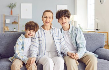 Sevgi dolu bir anne, küçük ve genç bir çocuk portresi olan ilgili bir kadın, hafta sonu evde birlikte vakit geçirin, çocuk gelişimi, iki nesildir aile sevgisi, kanepede oturmak, destek olmaktan mutlu olun.