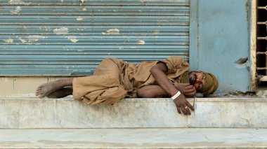 Yol kenarında uyuyan bir işçinin zoom çekimi 