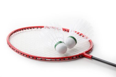 Badminton raketleri ve mekik horozu beyaz grupta izole edilmiş.