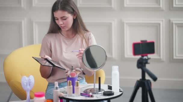 美容美发博客女性正在为她的频道进行化妆教学 在智能手机摄像机前展示眼影 在社交媒体上分享 为粉丝和化妆少女现场直播 — 图库视频影像