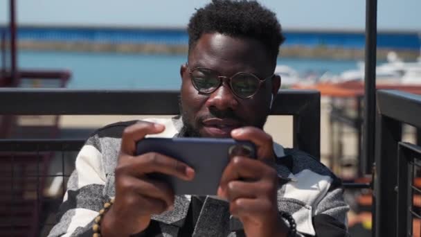 Outdoor Shot Van Een Jonge Zwarte Man Een Bril Spelen — Stockvideo