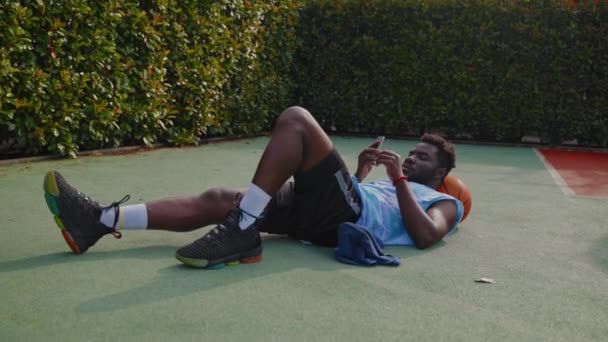 Cool Black Guy Resting Basketball Training Street Court Lying Ground — Stock Video